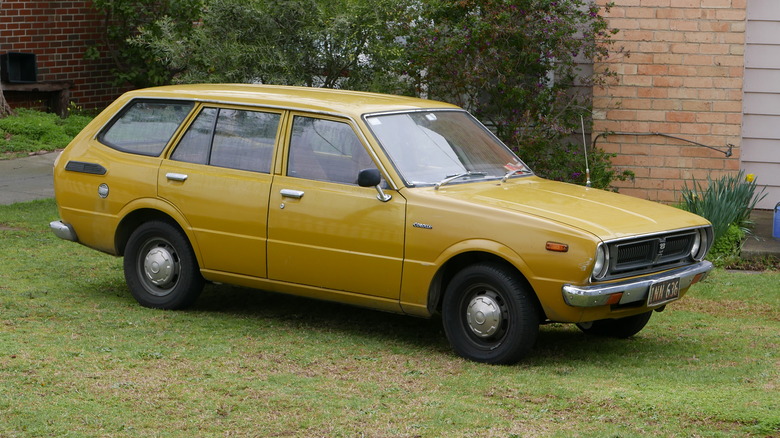 A 1976 Toyota Corolla parked connected a writer lawn
