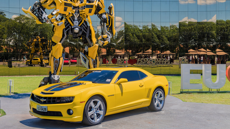 A yellow Chevrolet Camaro in front of Bumblebee