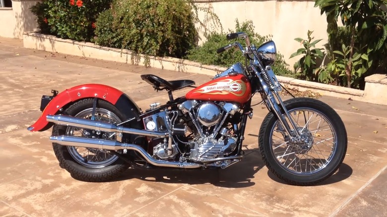 A red 1940 Harley-Davidson EL Knucklehead parked in a driveway