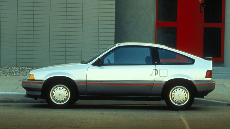 A two-toned 1987 Honda CR-X HF parked near a sidewalk.