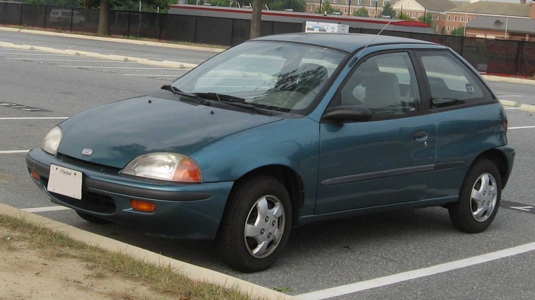 A 1995 Geo Metro sits in an empty parking lot.
