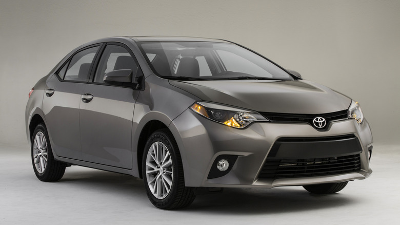 A silver 2014 Toyota Corolla LE Eco sits for a press photo.