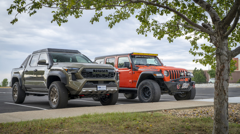 Loveland, CO, USA - August 22, 2025: Toyota Tacoma truck in Trailhunter trim and Jeep Wrangler Rubicon.