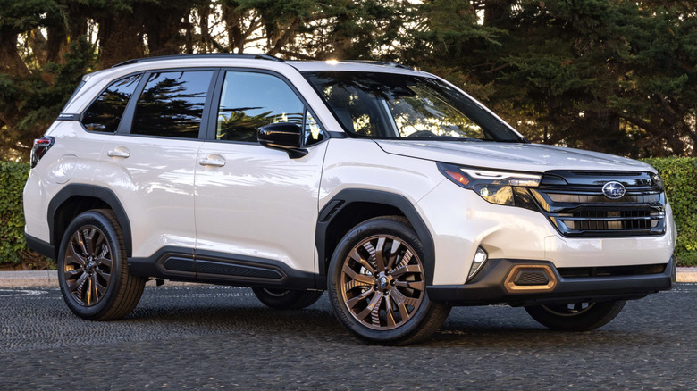 front right view of white 2025 Subaru Forester on slate tile driveway