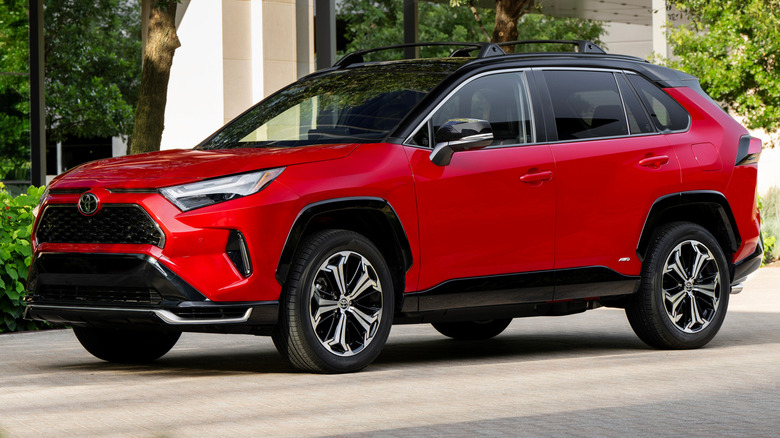 red 2025 Toyota RAV4 PHEV XSE parked on grey brick driveway