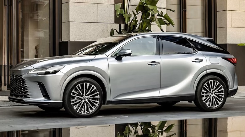 left side view of silver Lexus RX parked on city sidewalk