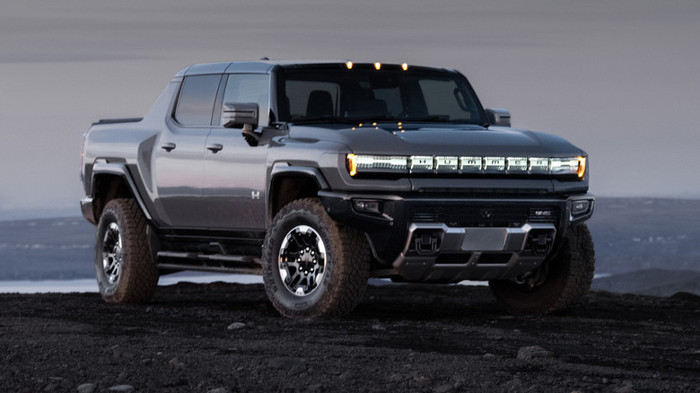 A gray GMC Hummer EV parked outdoors in grim weather-
