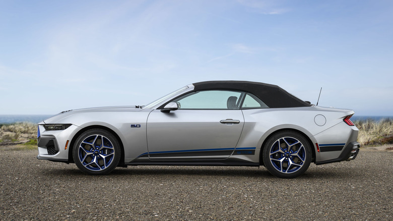 Side view of a silver Ford Mustang convertible