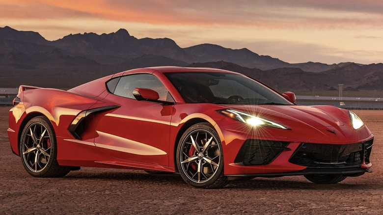 red Chevrolet Corvette C8 parked in front of mountains