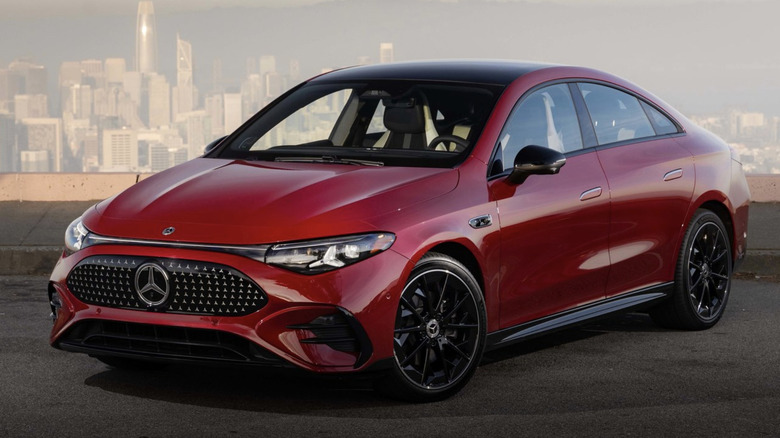 Red Mercedes-Benz CLA EV parked in front of a city