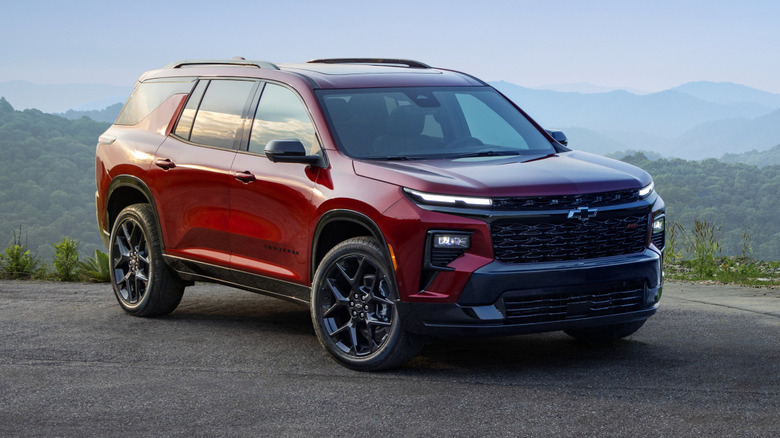A front 3/4 view of a red preproduction 2025 Chevy Traverse RS