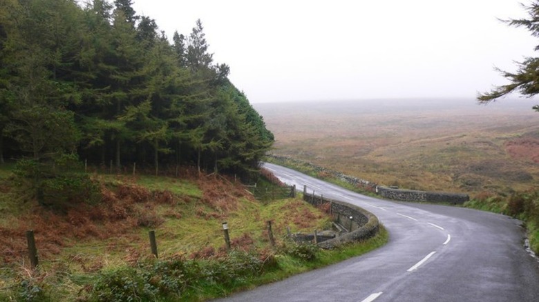 a country road in the Isle of Man with fog in the background
