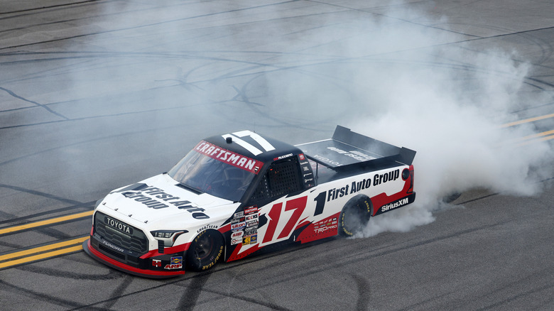 TALLADEGA, ALABAMA - OCTOBER 17: Giovanni Ruggiero, driver of the #17 First Auto Group Toyota, celebrates with a burnout after winning the NASCAR Craftsman Truck Series Love's RV Stop 225 at Talladega Superspeedway on October 17, 2025 in Talladega, Alabama.