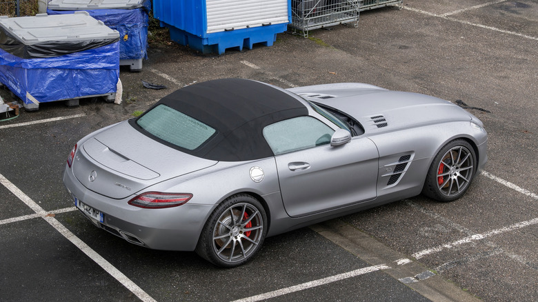 View on a matte grey Mercedes-Benz SLS AMG Roadster parked on a parking lot.