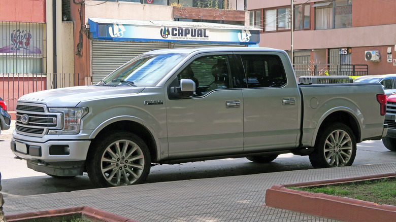 2019 Ford F-150 Limited in parked at side of the road with buildings in the background