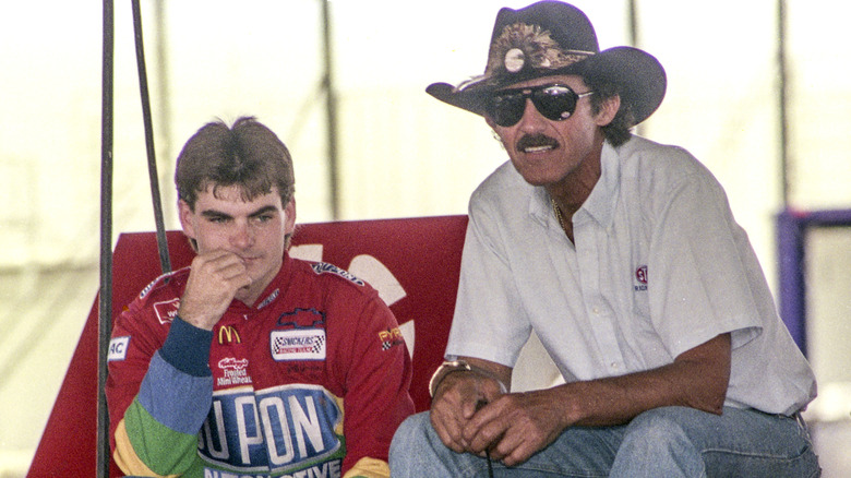 Jeff Gordon (L) in the second year of his career, talks with retired NASCAR racing legend Richard Petty in the garage at Talladega Superspeedway circa May 1994 in Talladega, Alabama