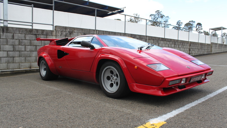 A red Lamborghini Countach LP 5000QV in a parking lot