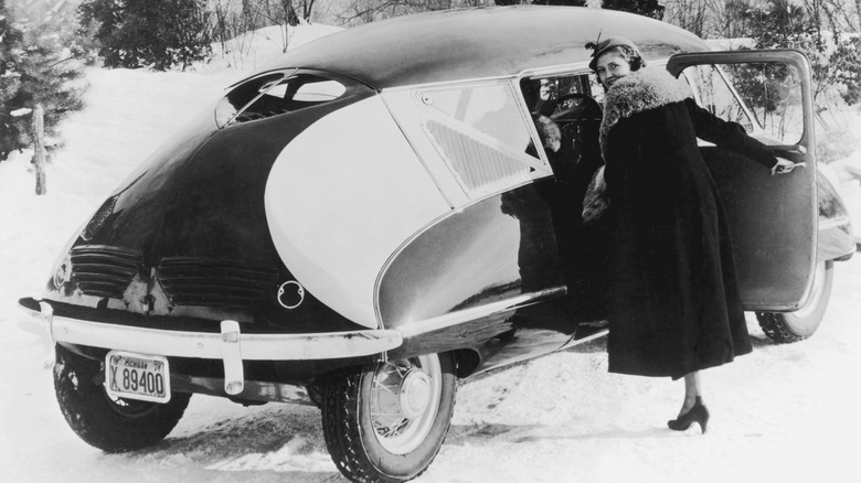 Vintage photo of a woman getting into a Stout Scarab