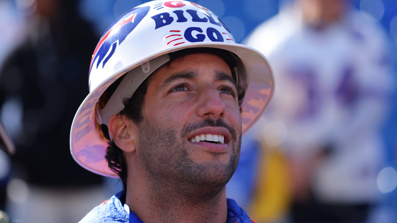Formula 1 driver Daniel Ricciardo on the sideline before a game between the Buffalo Bills and the Miami Dolphins at Highmark Stadium on November 3, 2024 in Orchard Park, New York.