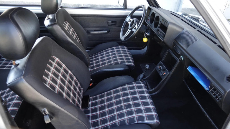 A look in the passenger side of a Mk1 GTI with its plaid seats