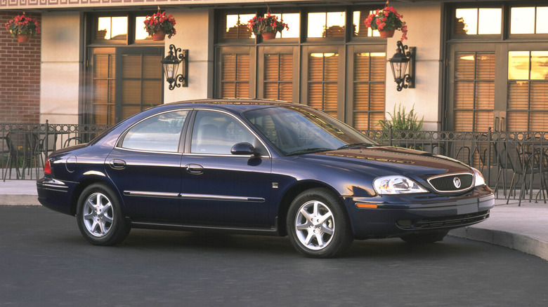 A catalog shot of a 2002 Mercury Sable in front of a nice patio area.