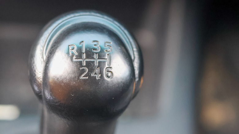 A close-up of a manual shifter knob.