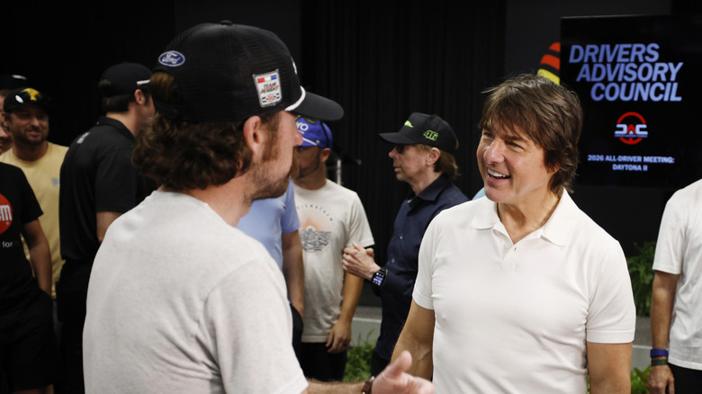 Tom Cruise speaks to guests at the NASCAR COKE ZERO SUGAR 400 at Daytona International Speedway on August 29, 2026, in preperation for Days of Thunder.