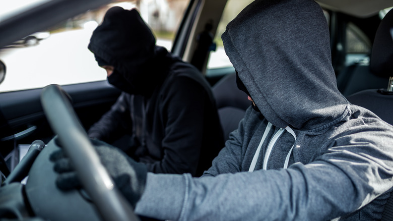 Two people inside a vehicle trying to steal it