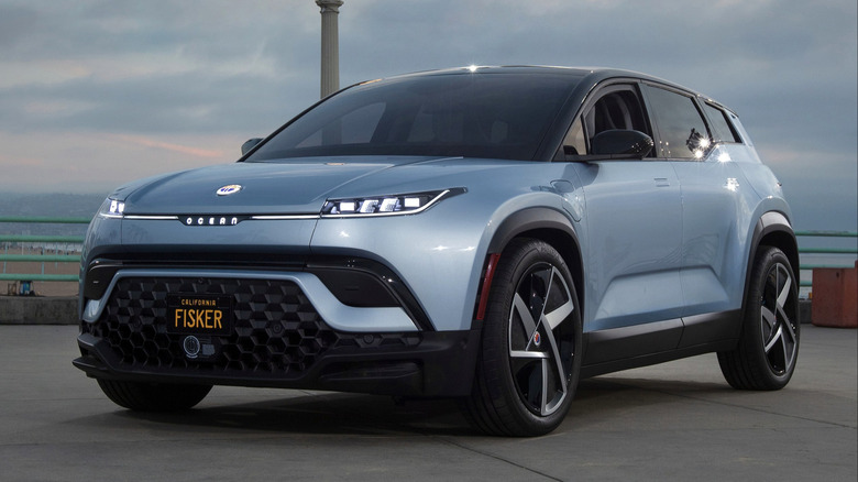 A fisker ocean suv parked on a riverwalk