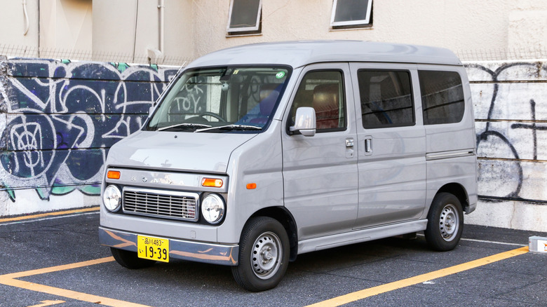A Honda Vamos parked in a parking spot surrounded by graffiti