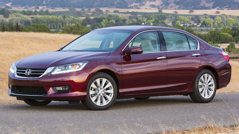 A maroon 2014 Honda Accord EX-L V6 Sedan parked on a paved road
