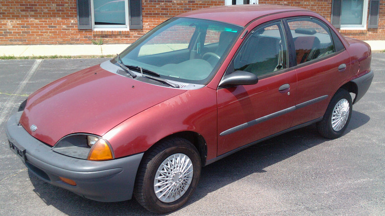 A reddish Geo Metro sedan from nan supra beforehand 3 quarter