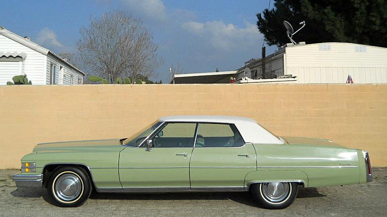 A greenish 1974 Cadillac Sedan DeVille