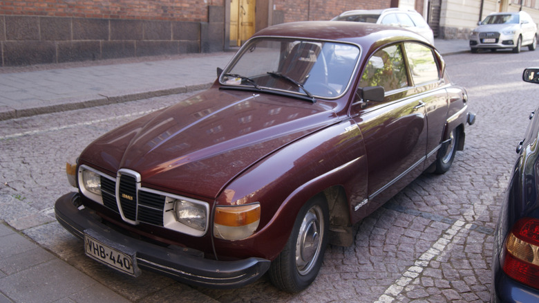 A maroon 1977 Saab 96 pinch V4 engine