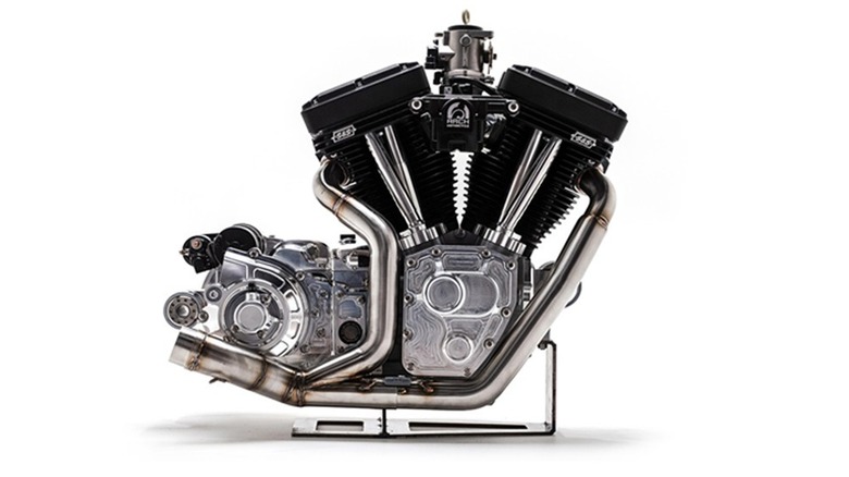 A closeup shot of an Arch/S&S V-Twin engine on a stand