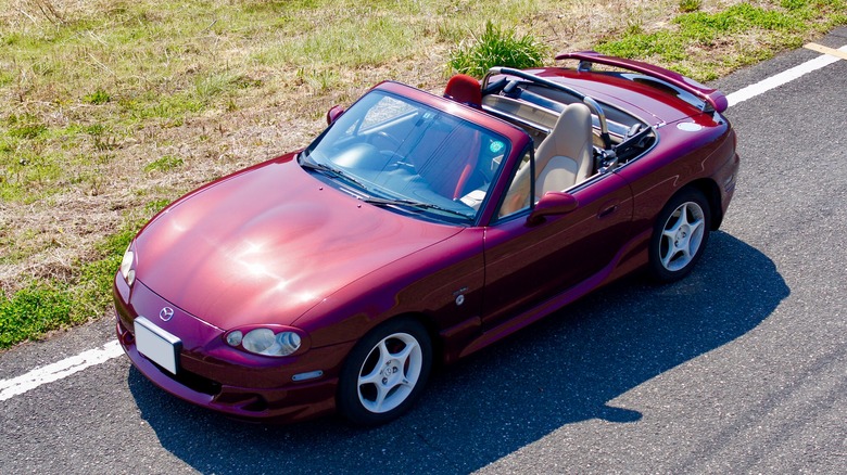 A dark red Mazda MX-5 Roadster viewed from a high angle