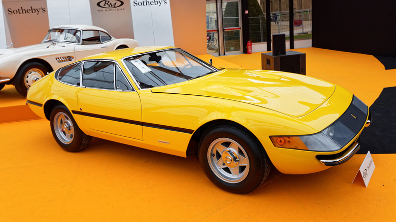 A yellow 1971 Ferrari Daytona Coupe on display in Paris