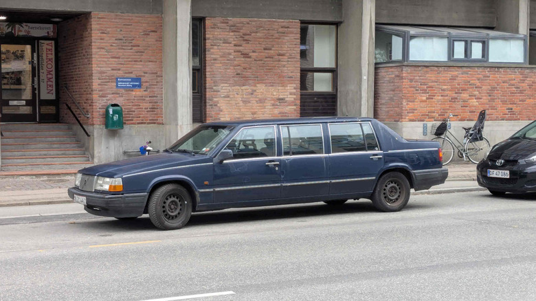 A blue Volvo limo parked on a European street