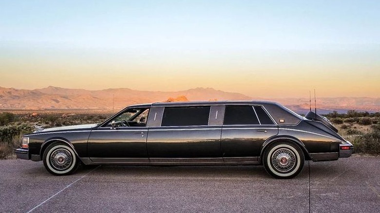 A side view of a black Cadillac Seville limo