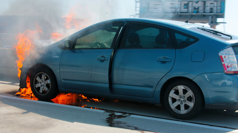 USA - March 12, 2025: Car Fire. Toyota Prius Electric vehicle on Fire on the I-5 Freeway in Los Angeles, California. Burning car close up. Big flames of fire and smoke. Fire