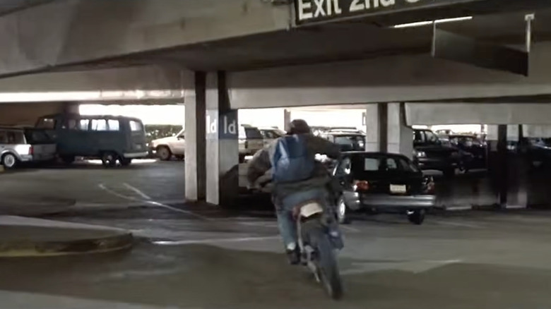 a kid riding a mountain bike through a parking garage