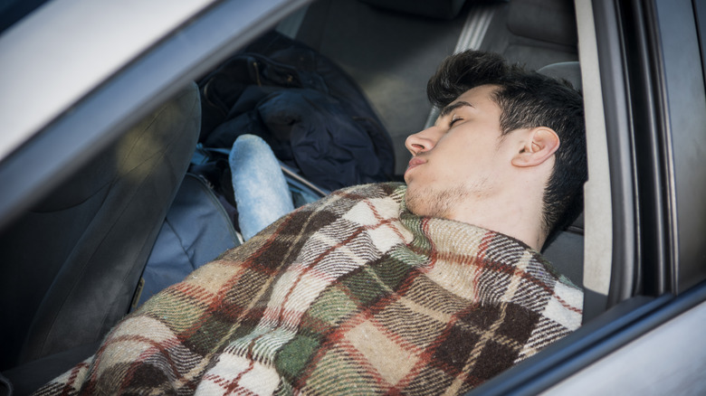 Man asleep in a car