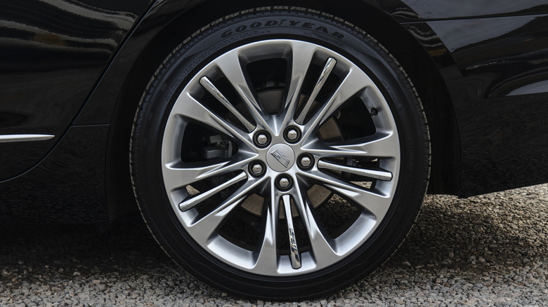 January 23, 2021, Seoul, South Korea - A detailed view of the rear wheel and Goodyear tire on a black Cadillac CT6 luxury sedan.