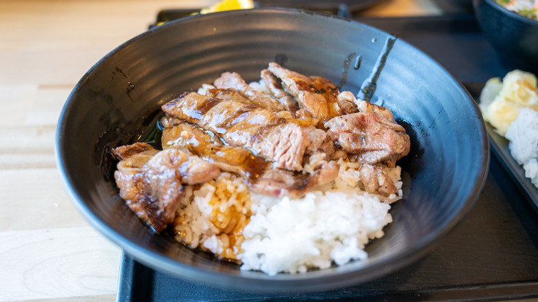 Beef rice bowl with grilled meat and sauce served in a black dish at a casual restaurant, Walnut Creek, California, March 25, 2026. (Photo by Smith Collection/Gado/Getty Images)