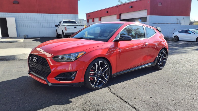 A red 2019 Hyundai Veloster N in a storage unit lot
