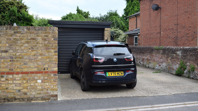 A black BMW i3 in a driveway