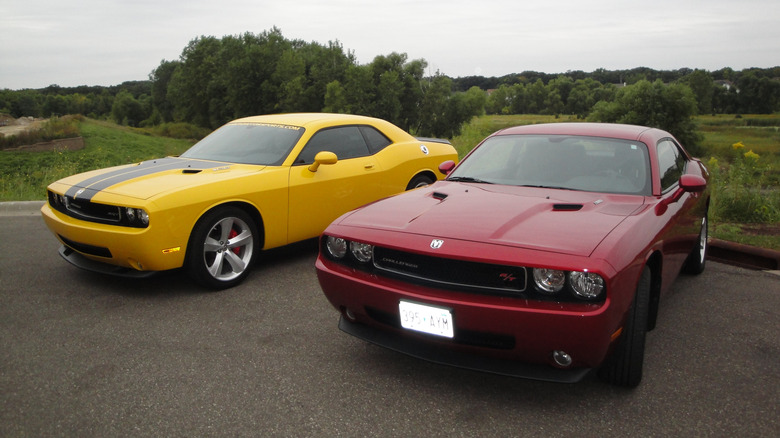 A pair of 2008 Dodge Challengers parked at a car show