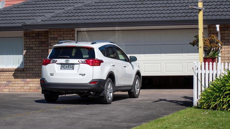 A white Toyota RAV4 in a driveway