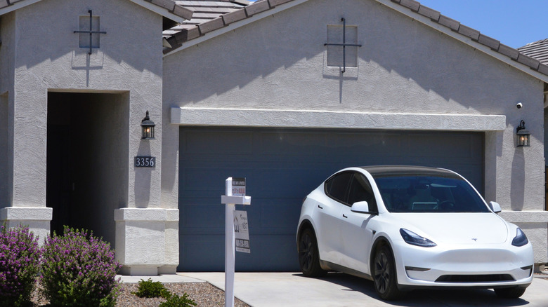 A white Tesla Model Y in a driveway