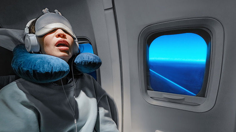 A woman in a deep sleep on a plane